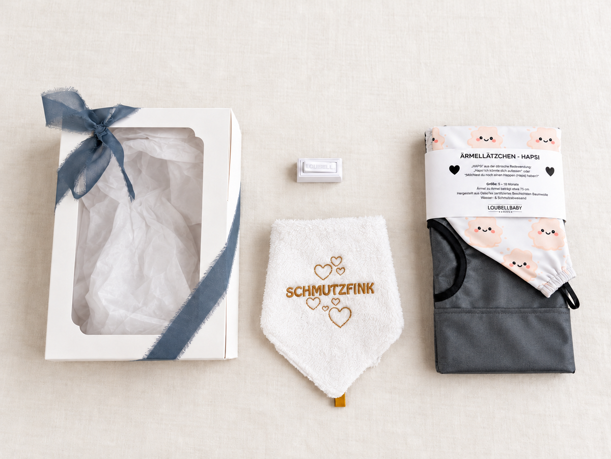 Geschenkbox, Waschtuch SCHMUTZFINK und HAPSI Klecksi Anthrazit nebeneinander
