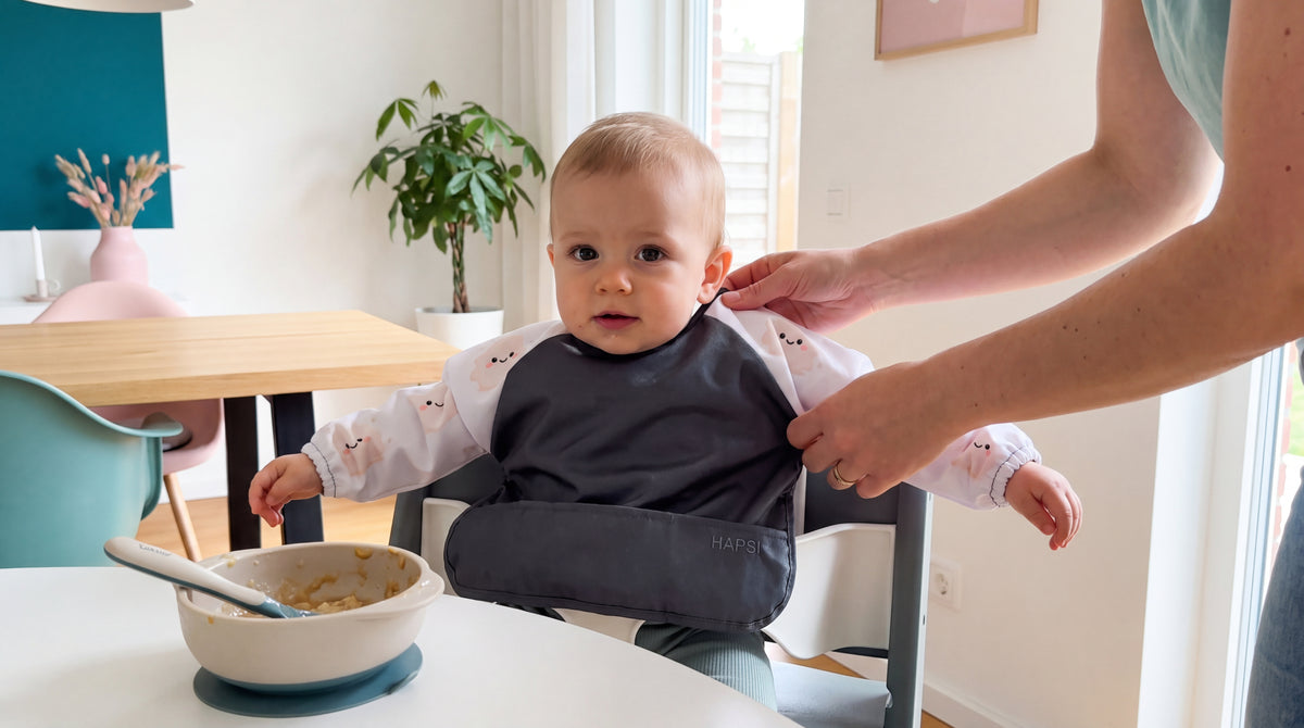 Baby mit HAPSI Anthrazit sitzt am Tisch vor einer Schale